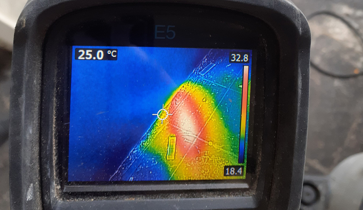 Thermal imaging camera identifying a temperature anomaly caused by a water leak