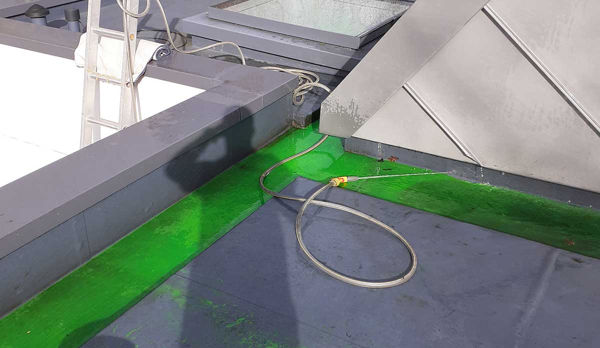 Flat roof being inspected for signs of water ingress and membrane damage